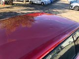 a red car parked on the side of the road