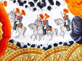a close up of a table cloth with a picture of a man on a horse