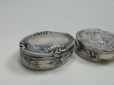 pair of antique silver plated boxes on a white surface