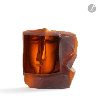 a glass sculpture of a face inside of a box