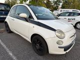 a small white car that is parked in a parking lot