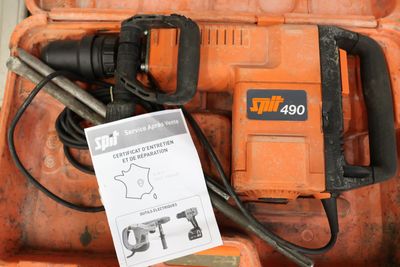 an orange box with a hammer and other tools in it