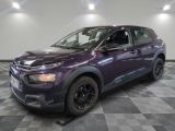 the purple car is parked on a checkered floor in the garage