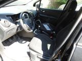 the interior of a car with a cell phone in the passenger seat