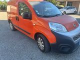 an image of a red and black van parked in a parking lot