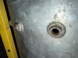 a hole in the side of a wall with a yellow door