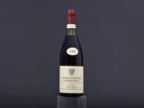 a bottle of wine sitting on top of a table next to a glass