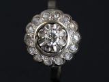 a close up of a diamond ring on a black surface