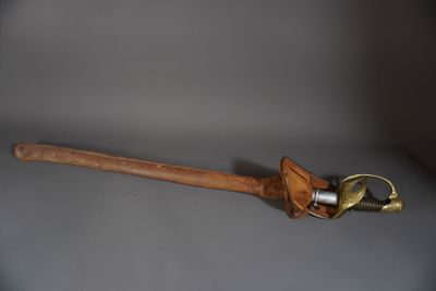 une batte de baseball en bois sur laquelle est enfilé un gant en cuir
