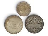 three canadian coins are shown on a white surface