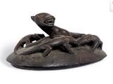 an image of a bronze statue of a woman laying on top of a rock