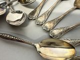a lot of silver spoons and spoon spoons on a table