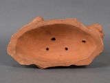 a close up of a clay object with holes in it