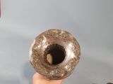 a person holding a donut in their hand
