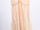 an image of a dress hanging on a hanger in front of a white wall