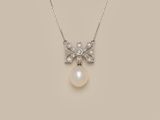 a white pearl and diamond pendant on a silver chain