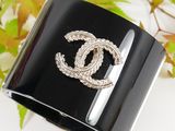 a close up of a bracelet with a chanel logo on it