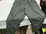 a pair of pants sitting on top of a bed in a room