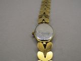 a close up of a wrist watch with a butterfly design on it