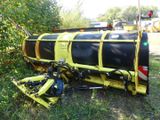 a yellow and black train that is sitting in the grass