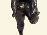 statue of a man holding a soccer ball on a marble base