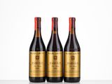 three bottles of wine sitting on top of a table next to each other
