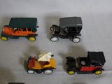several toy cars are lined up in a row on a white surface