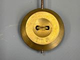a clock hanging on the wall with a key in it