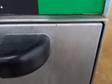 a close up of a trash can with a sign on it