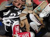 many pairs of shoes sitting in a pile on the floor