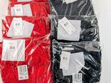 four pairs of red, black and white shirts in plastic bags