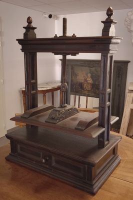 a wooden bed in a room with a painting on the wall