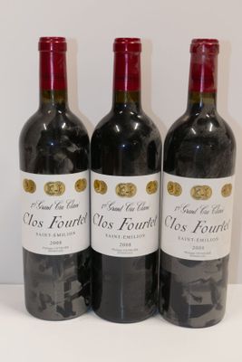 trois bouteilles de vin rouge sont alignées sur une table