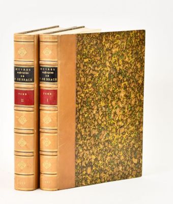 two books sitting on top of each other on a white surface