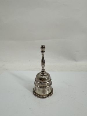 an antique silver plated candle holder on a white surface