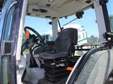 a close up of the driver ' s seat in the cab of a tractor