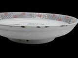 a white bowl with a red and blue design on it