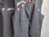two men ' s vests that are hanging on a wall