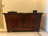a wooden chest sitting in the middle of a room