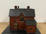 a small model of a house sitting on a table