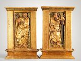 pair of carved wooden statues of a man and a woman