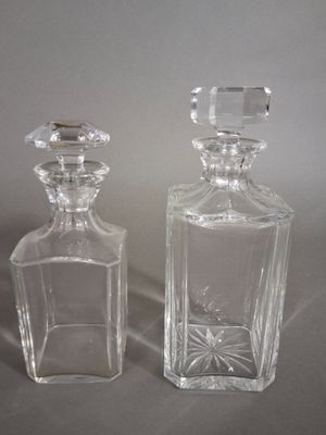 two glass bottles that are sitting next to each other