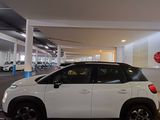 a picture of a white car parked in a parking garage