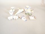 a lot of small pieces of porcelain sitting on a table