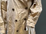 an image of a mannequin wearing a beige trench coat