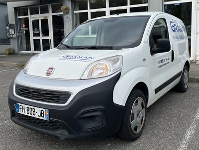 a white van that is parked in front of a building
