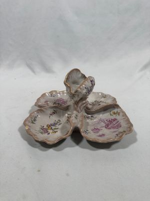 a small white plate with a flower on it