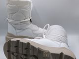 pair of white snow boots on a white surface with a white background