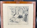 an old picture of a dog laying on the ground in front of a wooden easel