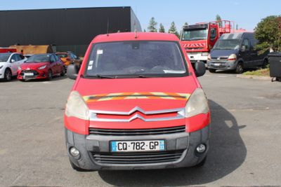 a red van that is parked in a parking lot